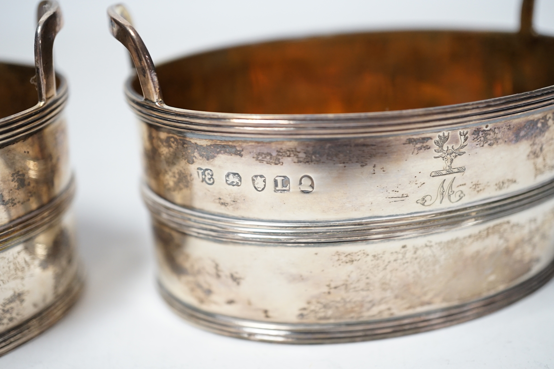 A pair of George III silver salts, modelled and oval two handled tubs, by John Emes, with reeded bands and engraved crest, 89mm.